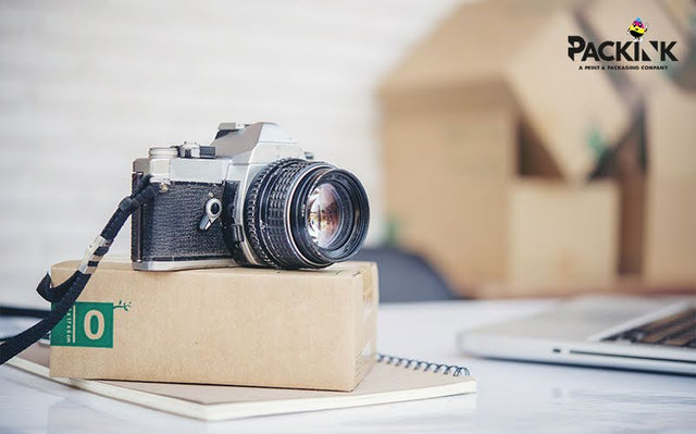 Fragile electronics camera and cardboard packaging.